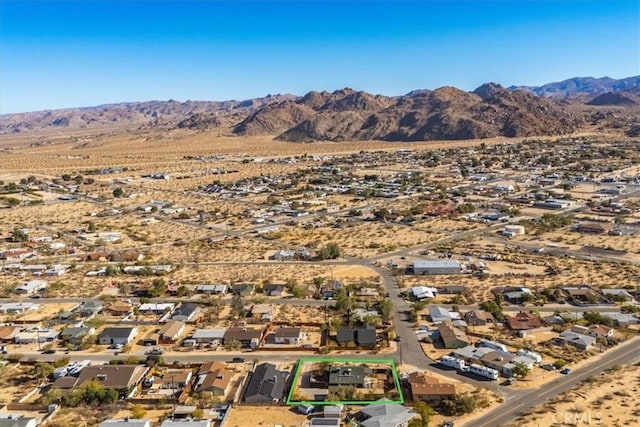 birds eye view of property with a mountain view