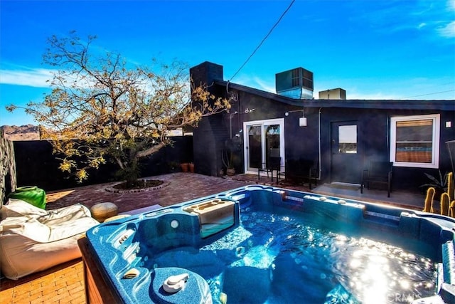 view of pool with a patio and a hot tub