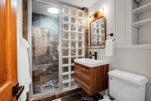 bathroom featuring tile patterned floors, a shower with door, vanity, and toilet