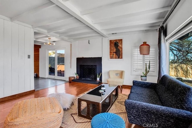 living room with beamed ceiling and hardwood / wood-style floors