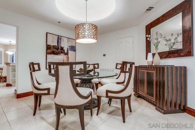 tiled dining space featuring a tray ceiling