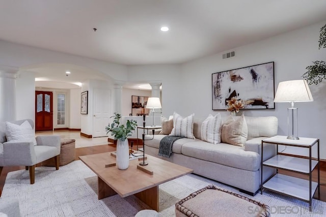 living room featuring decorative columns