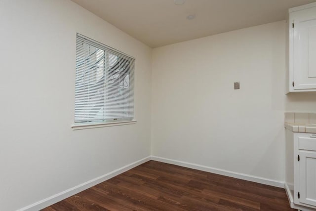 unfurnished dining area with dark hardwood / wood-style floors