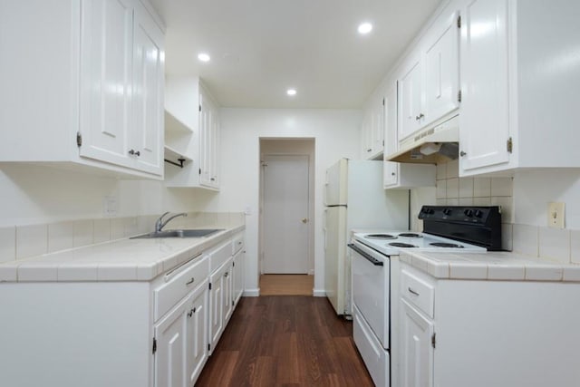 kitchen featuring tile countertops, white electric stove, white cabinetry, sink, and dark hardwood / wood-style flooring