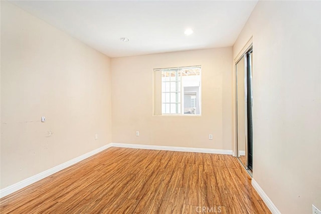 spare room with hardwood / wood-style floors