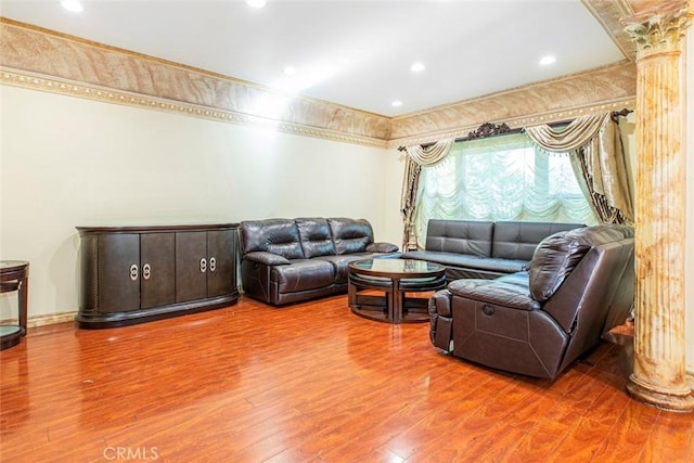 living room with ornate columns and hardwood / wood-style flooring