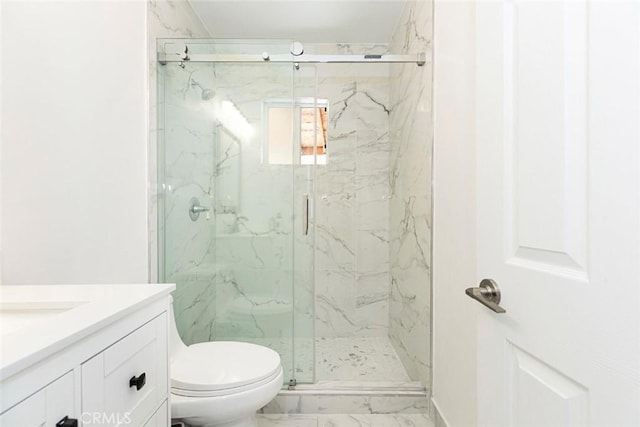 bathroom with vanity, an enclosed shower, and toilet