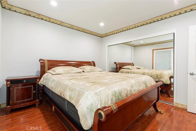 bedroom featuring a closet and dark wood-type flooring