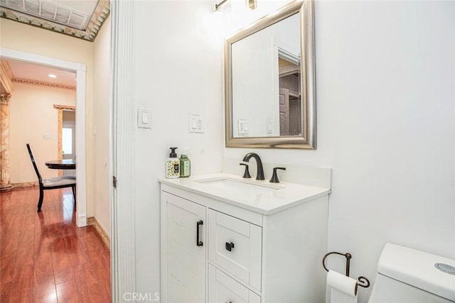 bathroom featuring hardwood / wood-style flooring, vanity, and toilet