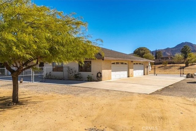 view of front of house featuring a mountain view and a garage