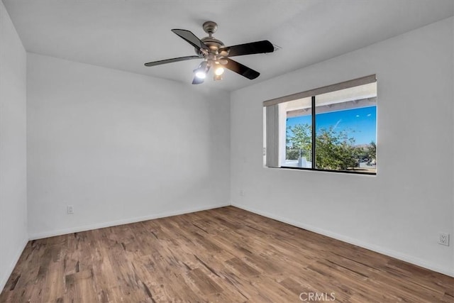 spare room featuring hardwood / wood-style flooring and ceiling fan