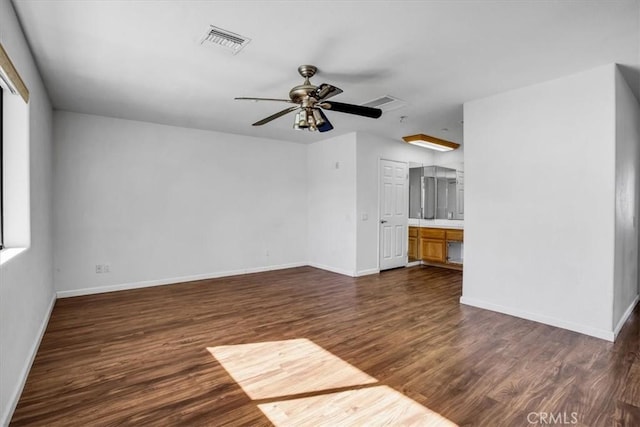 unfurnished living room with ceiling fan and dark hardwood / wood-style flooring