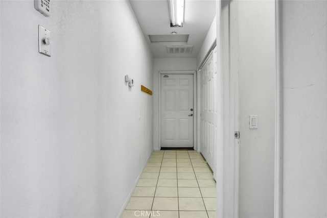 hall with light tile patterned floors