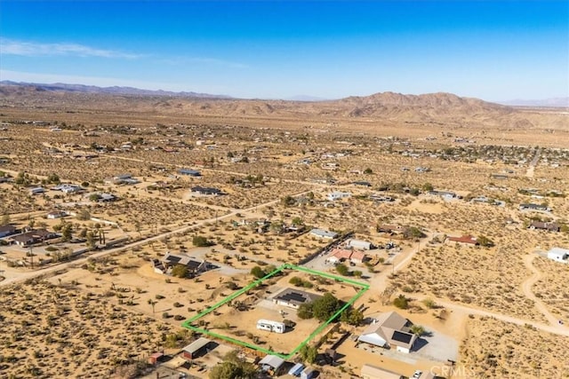 birds eye view of property featuring a mountain view