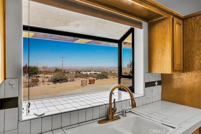 interior space with tile counters and sink