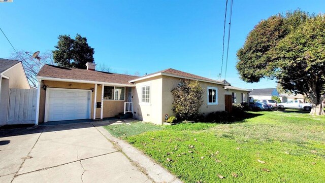 single story home with a garage and a front lawn