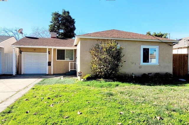 view of front of property with a garage and a front yard