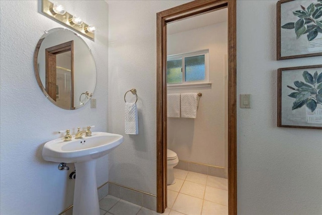 bathroom with tile patterned floors and toilet