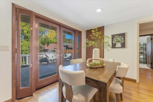 dining area with light hardwood / wood-style flooring and french doors