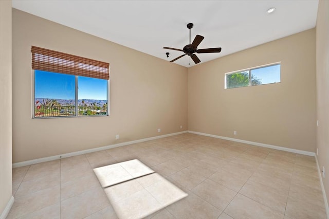 tiled spare room with ceiling fan