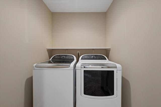 laundry area with washing machine and clothes dryer