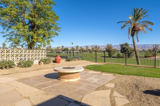 view of patio / terrace featuring a mountain view and a fire pit