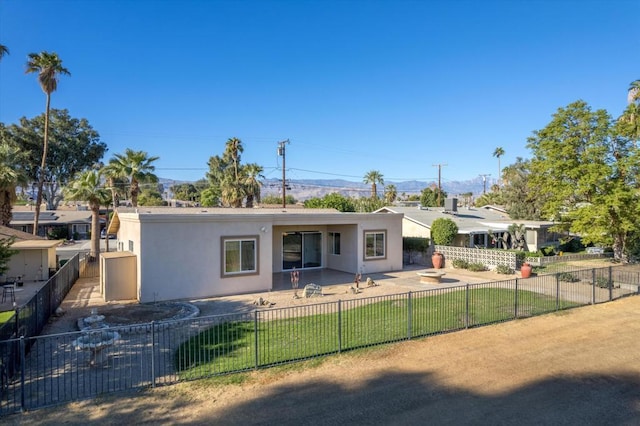 view of front of house featuring a front lawn and a patio area