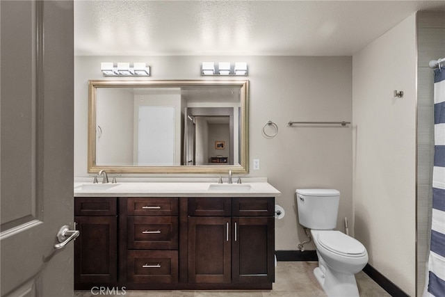 bathroom featuring toilet, vanity, tile patterned flooring, and a shower with curtain