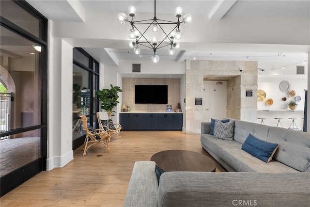 living room featuring an inviting chandelier, a wall of windows, hardwood / wood-style flooring, and beamed ceiling