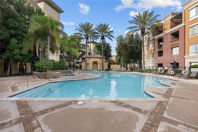 view of pool featuring a hot tub and a patio