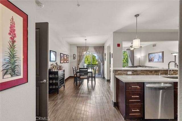 kitchen with pendant lighting, dishwasher, dark hardwood / wood-style flooring, sink, and dark brown cabinets