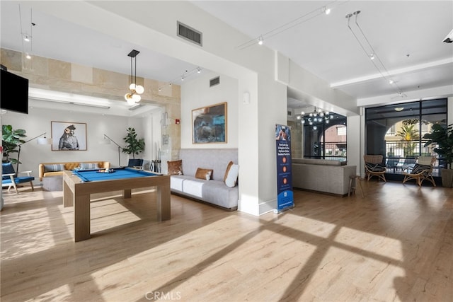 game room with pool table, track lighting, and hardwood / wood-style floors