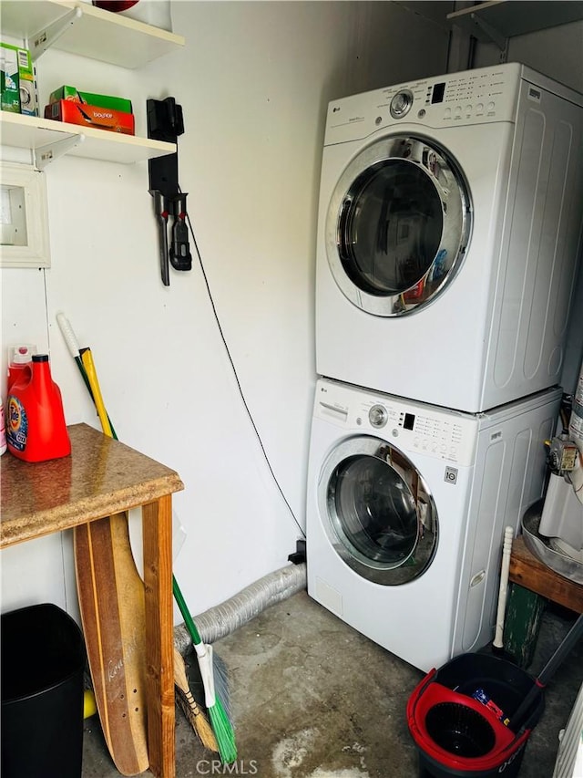 laundry room featuring stacked washer and clothes dryer