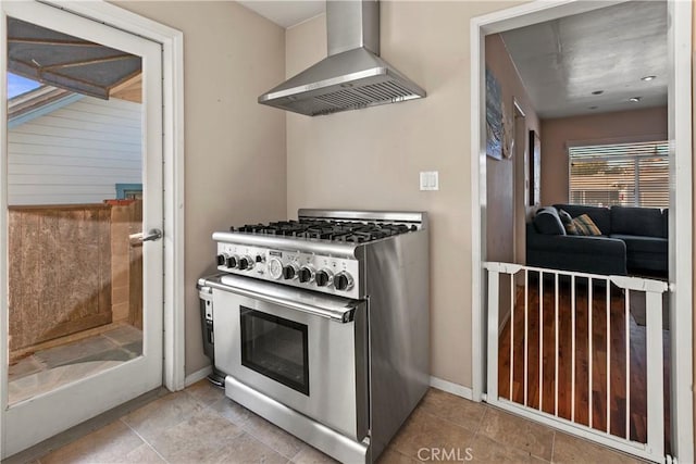 kitchen featuring wall chimney range hood and high end stainless steel range