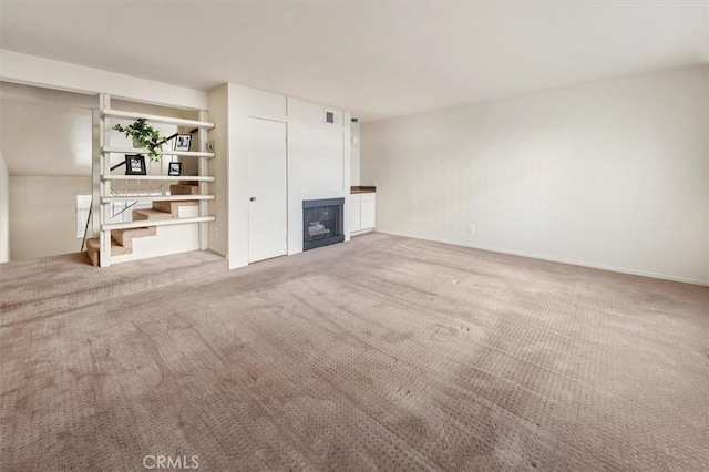 unfurnished living room featuring carpet