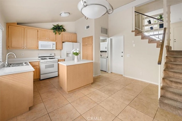 kitchen featuring light brown cabinetry, sink, a center island, light tile patterned floors, and white appliances