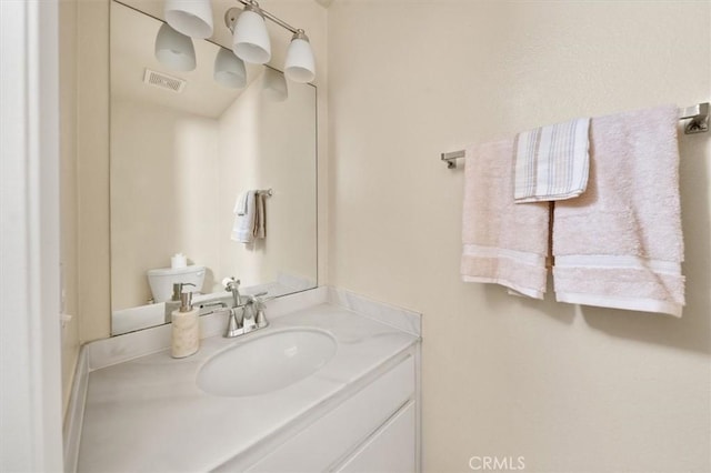 bathroom featuring vanity and toilet