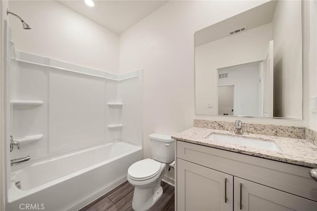 full bathroom featuring vanity, toilet, wood-type flooring, and shower / washtub combination