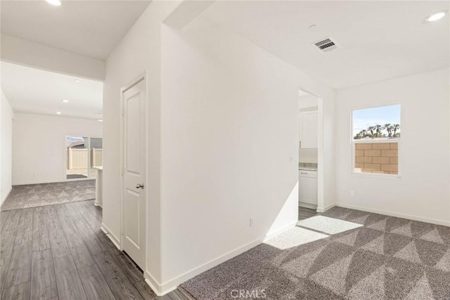 hall with recessed lighting, dark wood-style flooring, visible vents, and baseboards