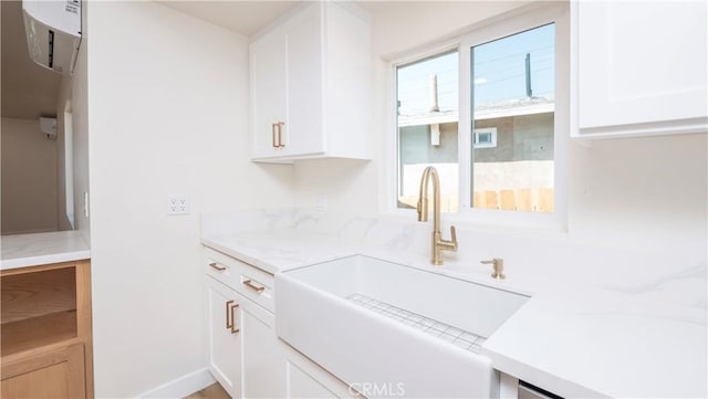 kitchen featuring a sink and white cabinets