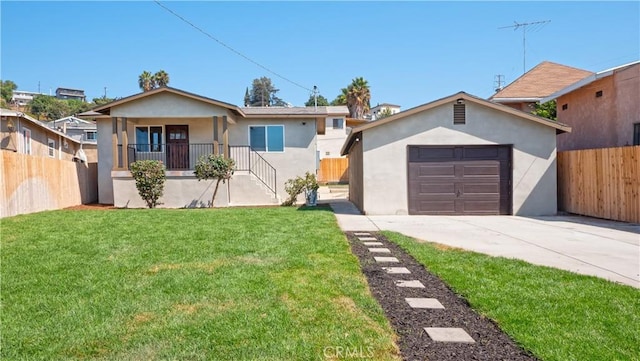 single story home with driveway, an outbuilding, fence, a front yard, and stucco siding