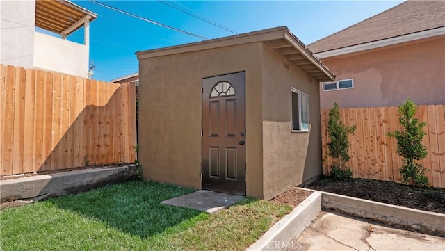 view of shed with a fenced backyard