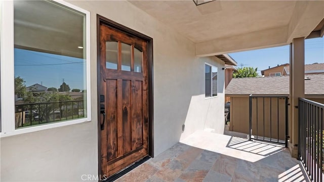 entrance to property with stucco siding