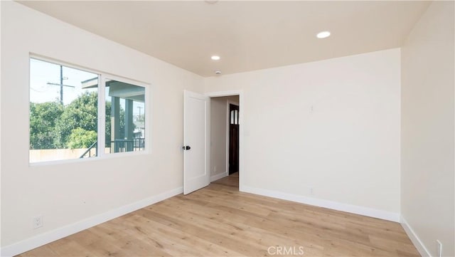 unfurnished room with light wood-style flooring, baseboards, and recessed lighting