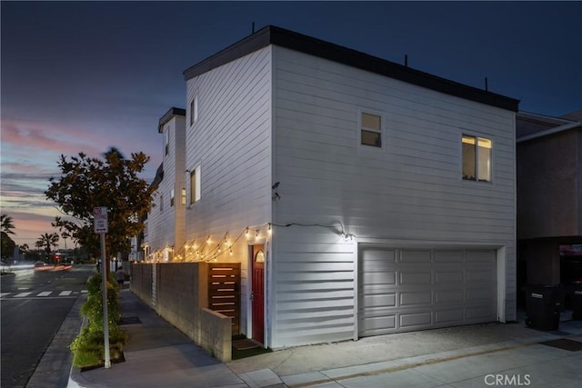 property exterior at dusk with a garage