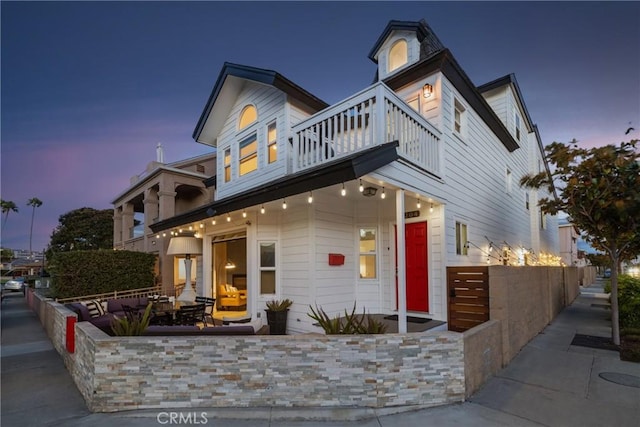 view of front of home with a patio area and a balcony