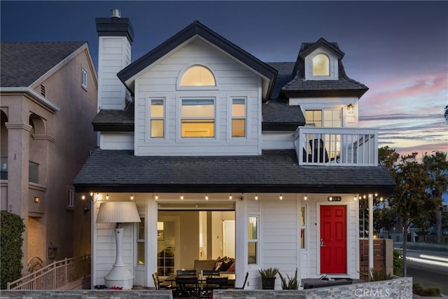 view of front of property featuring a balcony