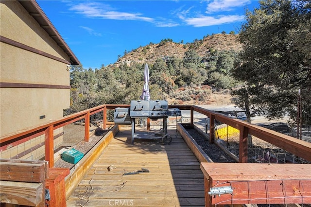 wooden terrace featuring a mountain view