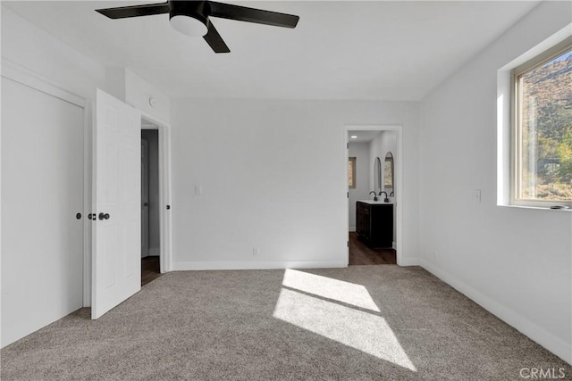 unfurnished bedroom featuring ceiling fan and carpet flooring