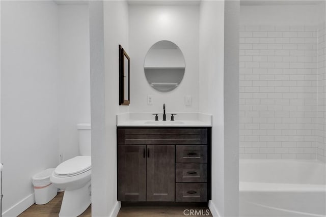 full bathroom with bathing tub / shower combination, hardwood / wood-style floors, vanity, and toilet